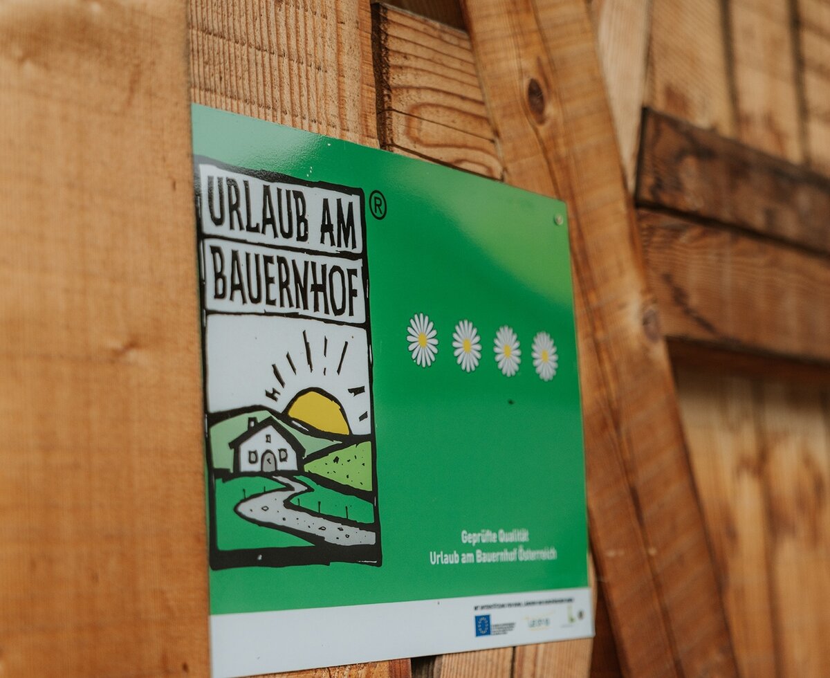 Il sigillo di qualità ufficiale 'Urlaub am Bauernhof' con 4 margherite del maso.